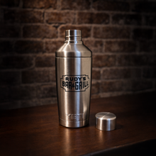 Load image into Gallery viewer, Rudy’s Bar &amp; Grill YETI stainless steel cocktail shaker with lid removed, displayed on a wooden bar.