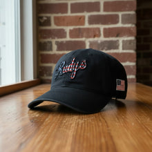 Load image into Gallery viewer, A black baseball cap featuring 'Rudys' embroidered on the front in a red, white, and black American flag pattern, with a small US flag patch on the side, set against a plain white background.
