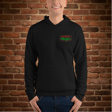 Load image into Gallery viewer, Person wearing Rudy’s Bar &amp; Grill Baron Von Swine Christmas Light Edition unisex hoodie, featuring festive Rudy’s Bar &amp; Grill logo on the front, black pullover, brick wall background