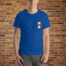 Load image into Gallery viewer, Front view of a true royal blue t-shirt featuring a small Baron Von Swine pig logo on the left chest, modeled in front of a brick wall at Rudy’s Bar &amp; Grill.