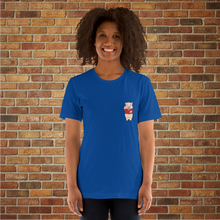 Load image into Gallery viewer, Front view of a woman wearing a true royal blue t-shirt featuring a small Baron Von Swine pig logo on the chest, smiling and posed in front of a brick wall at Rudy’s Bar &amp; Grill.