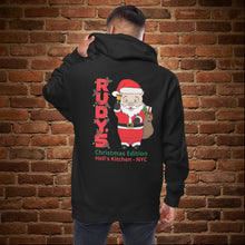 Load image into Gallery viewer, Back of Rudy’s Bar &amp; Grill Christmas Edition zip hoodie featuring Baron Von Swine as Santa Claus, with festive text and Hell’s Kitchen NYC, shown on a brick wall background