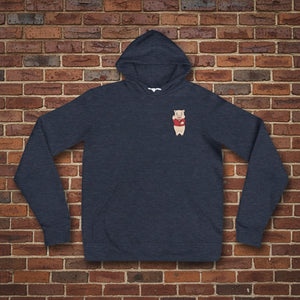 Navy blue hoodie featuring a small Baron Von Swine pig mascot graphic on the chest, displayed flat against a reddish-brown textured brick wall background. The hoodie is centered and well-lit for a realistic