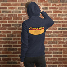 Load image into Gallery viewer, Person wearing Navy blue hoodie featuring a large Rudy’s Bar &amp; Grill hot dog logo on the back, displayed against a reddish-brown textured brick wall background. The hoodie is centered and well-lit, creating a realistic product mockup for Rudy’s Bar &amp; Grill merchandise