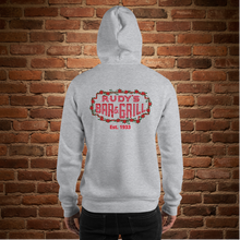 Load image into Gallery viewer, Back of sport grey Rudy’s Bar &amp; Grill hoodie featuring neon sign logo and Est. 1933, brick wall background