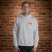 Load image into Gallery viewer, Model wearing sport grey Rudy’s Bar &amp; Grill hoodie with Cupid Pig graphic on front, brick wall background