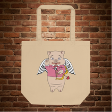 Load image into Gallery viewer, Eco tote bag with Baron Von Swine as Cupid design, displayed flat against a brick wall background