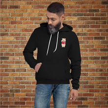 Load image into Gallery viewer, Male model wearing Rudy’s Bar Back Hoodie in black, featuring Baron Von Swine mascot chest logo, brick wall background