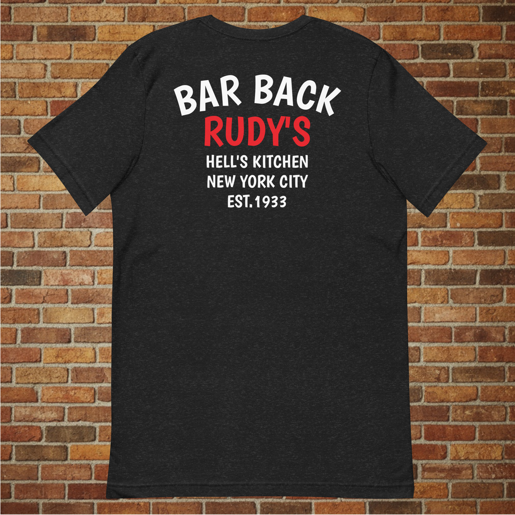 Back of Rudy’s Bar & Grill Bar Back T-Shirt with “Bar Back Rudy’s Hell’s Kitchen New York City Est. 1933” printed, displayed against a brick wall background