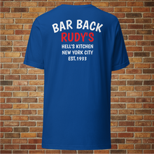 Load image into Gallery viewer, Back of Rudy’s Bar &amp; Grill Bar Back T-Shirt in royal blue with “Bar Back Rudy’s Hell’s Kitchen New York City Est. 1933” printed, displayed against a brick wall background