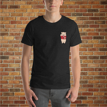 Load image into Gallery viewer, Front of Rudy’s Bar &amp; Grill Bar Back T-Shirt in black heather, worn by a male model, featuring the Baron Von Swine mascot, displayed against a brick wall background