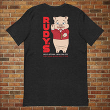 Load image into Gallery viewer, Classic Rudy’s Bar &amp; Grill black t-shirt laid flat, back view featuring Baron Von Swine mascot and red Rudy’s text, brick wall background