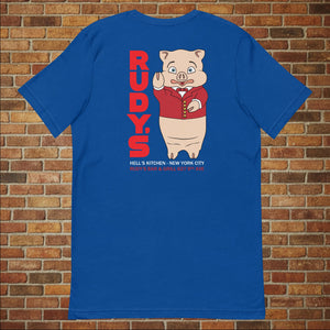 Classic Rudy’s Bar & Grill true royal blue t-shirt laid flat, back view featuring Baron Von Swine mascot and red Rudy’s text, brick wall background