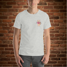 Load image into Gallery viewer, Person wearing Rudy’s Bar &amp; Grill athletic heather t-shirt with Cupid Pig graphic on front, brick wall background
