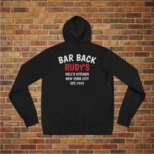 Load image into Gallery viewer, Back view of Rudy’s Bar &amp; Grill Bar Back Hoodie in black, featuring “BAR BACK RUDY’S HELL’S KITCHEN NEW YORK CITY EST. 1933” text, on a brick wall background