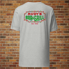 Load image into Gallery viewer, Back ghost mockup of Rudy’s Bar &amp; Grill Christmas Neon Sign T-Shirt – festive neon NYC dive bar logo, holiday shirt, brick wall background