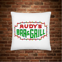 Load image into Gallery viewer, Rudy’s Bar &amp; Grill logo with colorful holiday lights on a white pillow, festive Christmas merchandise design