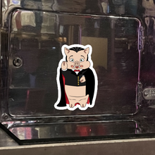 Load image into Gallery viewer, Baron Von Swine Dracula magnet from Rudy’s Bar &amp; Grill displayed on a metal surface – Halloween 2025 NYC bar merchandise collectible