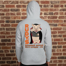Load image into Gallery viewer, Person wearing Rudy’s Bar &amp; Grill Dracula Pig Halloween Edition unisex hoodie, back view, in front of a red-brown brick wall.