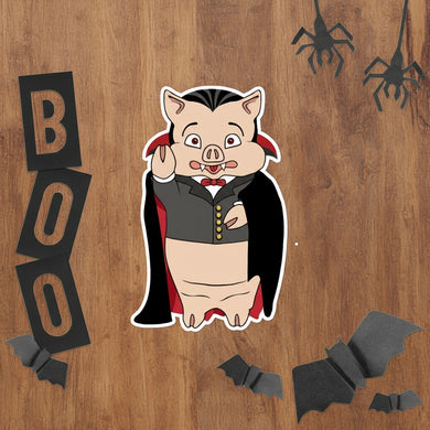 Rudy’s Bar & Grill Dracula Pig Halloween sticker with Halloween decorations, including bats and spiders, on a rustic wood background
