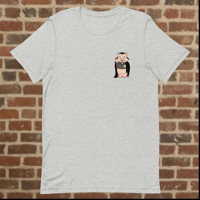 Rudy’s Bar & Grill Halloween t-shirt front in athletic heather, featuring Baron Von Swine dressed as Dracula on the left chest, displayed against a brick wall background