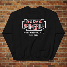 Load image into Gallery viewer, Back view of Rudy’s Bar &amp; Grill Neon Sign sweatshirt in black, displaying the bar’s logo with Hell’s Kitchen, NYC, Est. 1933