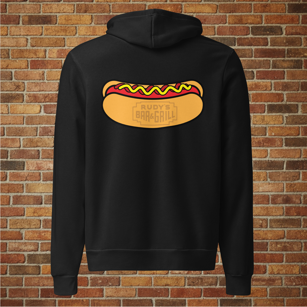 Back view of Rudy’s Bar & Grill unisex black hoodie featuring a large hot dog graphic with the bar’s logo inside the bun