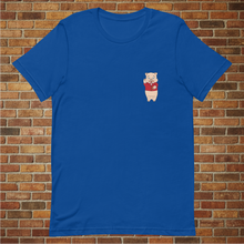 Load image into Gallery viewer, Front view of a true royal blue t-shirt with a small Baron Von Swine pig logo on the chest, modeled in front of a brick wall.