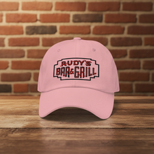 Load image into Gallery viewer, Rudy’s Bar &amp; Grill pink dad hat with neon sign logo, classic NYC bar merch on brick wall, Valentine’s Day edition