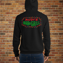 Load image into Gallery viewer, Back view of black Rudy’s Bar &amp; Grill holiday hoodie featuring the neon bar sign with Christmas lights, worn by a male model