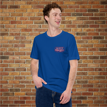 Load image into Gallery viewer, Person wearing Rudy’s Bar &amp; Grill Saxophone Pig T-shirt in true royal blue, front view, standing in front of a brick wall