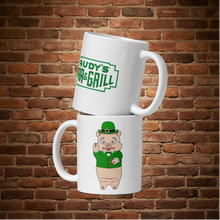 Load image into Gallery viewer, Rudy’s Bar &amp; Grill St. Patrick’s Day mug with Baron Von Swine and neon sign graphic, front view
