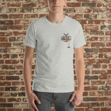 Load image into Gallery viewer, Male model wearing Rudy’s Bar &amp; Grill Halloween edition t-shirt with bat and spider logo on athletic heather shirt, brick wall background