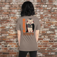 Load image into Gallery viewer, Female model wearing Rudy’s Bar &amp; Grill Halloween t-shirt with vampire pig cartoon and orange “RUDY’S” text on back, brick wall background