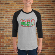 Load image into Gallery viewer, Rudy’s Bar NYC Christmas Neon Sign 3/4 Sleeve Raglan Shirt in heather grey with black sleeves, shown on male model in front of brick wall