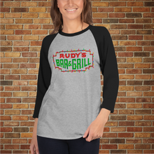 Load image into Gallery viewer, Rudy’s Bar NYC Christmas Neon Sign 3/4 Sleeve Raglan Shirt in heather grey with black sleeves, shown on model in front of brick wall