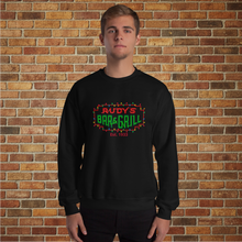 Load image into Gallery viewer, Model wearing Rudy’s Bar &amp; Grill Christmas Neon Sign Sweatshirt in black, front view, brick wall background