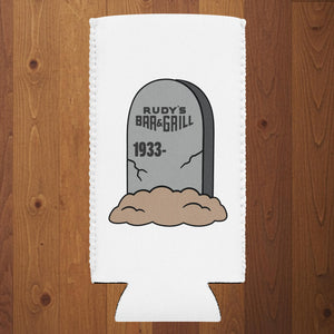 Rudy’s Bar & Grill Halloween can cooler featuring a tombstone graphic with “Rudy’s Bar & Grill 1933–” on a white slim koozie, wood background