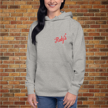 Load image into Gallery viewer, Carbon grey Rudy&#39;s Bar &amp; Grill front entrance unisex hoodie on female model against brick wall