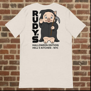 Back view of Rudy’s Bar & Grill Halloween Edition heather dust t-shirt featuring Baron Von Swine dressed as the Grim Reaper with vertical "RUDY’S" text and "Halloween Edition Hell’s Kitchen - NYC" below, displayed on a brick wall background
