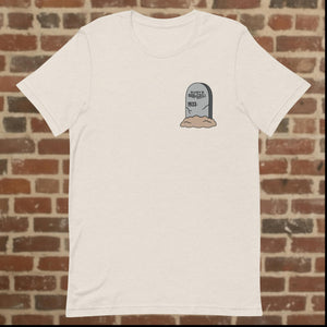 Front view of Rudy’s Bar & Grill Halloween Edition heather dust t-shirt with a tombstone graphic reading "Rudy’s Bar & Grill 1933-" on the left chest, set against a brick wall background