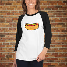Load image into Gallery viewer, Female model wearing Rudy’s Bar &amp; Grill Hot Dog 3/4 Sleeve Baseball Shirt in white with black sleeves, featuring a hot dog graphic, standing in front of a brick wall background