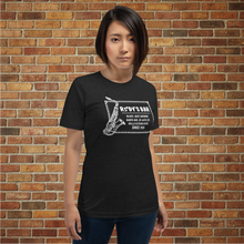 Load image into Gallery viewer, Female model wearing Rudy’s Bar &amp; Grill Jazz Saxophone T-Shirt in front of a brick wall
