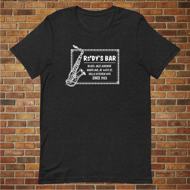Rudy’s Bar & Grill Jazz Saxophone T-Shirt displayed flat against a brick wall background