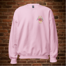 Load image into Gallery viewer, Light pink crew neck sweatshirt with Baron Von Swine holding a heart on the front, displayed flat against a brick wall background