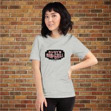 Load image into Gallery viewer, Female model wearing Rudy’s Bar &amp; Grill Neon Sign T-Shirt in athletic heather, standing in front of a brick wall