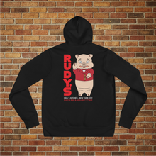 Load image into Gallery viewer, Flat lay of black hoodie showing Rudy’s Bar &amp; Grill pig mascot and Hell’s Kitchen NYC address on back, displayed against brick wall background
