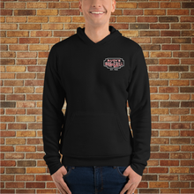 Load image into Gallery viewer, Front view of black hoodie with Rudy’s Bar &amp; Grill logo on chest, shown on tattooed model in front of brick wall