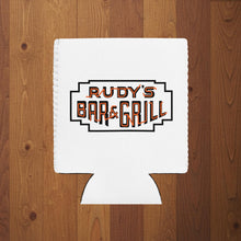 Load image into Gallery viewer, White can cooler featuring Rudy’s Bar &amp; Grill neon sign logo on wood background