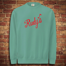 Load image into Gallery viewer, Seafoam Rudy’s St. Patrick’s Day crewneck sweatshirt flat front view with red Rudy’s logo, brick wall background.